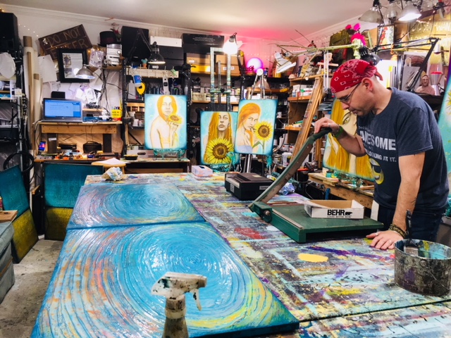 Rafi in a messy art studio