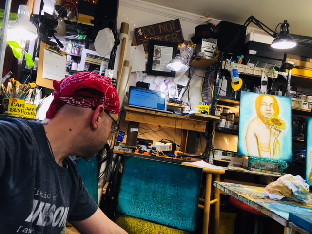 Rafi in a messy art studio