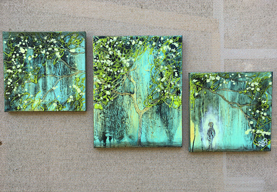Three abstract paintings featuring vibrant trees with green and yellow leaves against a textured blue background.