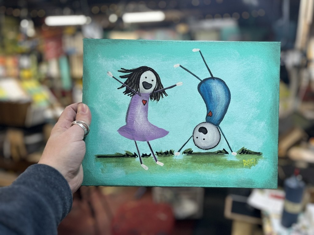 A colorful painting depicting a girl in a purple dress joyfully dancing while a boy performs a handstand, set against a bright turquoise background.