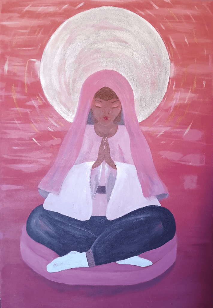 A woman meditating in a seated position on a circular cushion, wearing a pink robe and headscarf, with eyes closed and hands together in prayer, set against a soft pink background with a glowing halo effect.